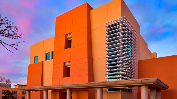 UNM's College of Education LEED building with purple sunset